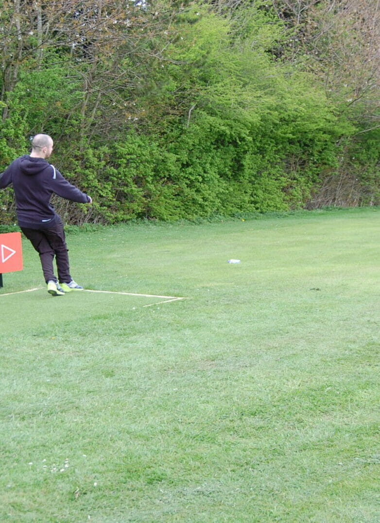 Person kicking a football off the tee at Footgolf