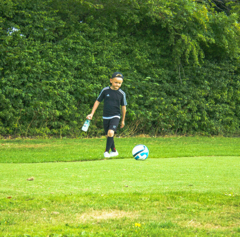 Child with a football at Footgolf