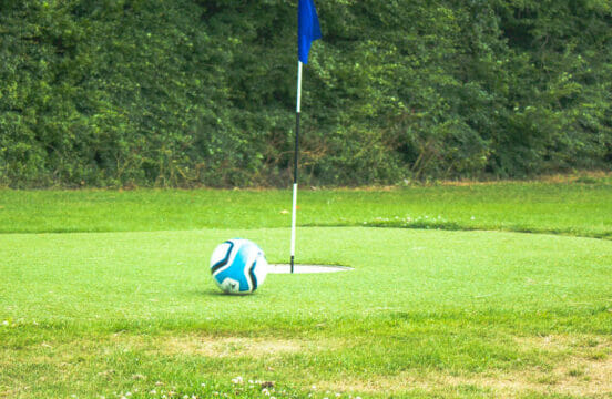 Football next to the flag at Footgolf
