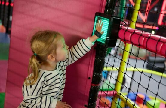 Child completing a Stompers X checkpoint by scanning their wristband against the light in the Stompers Play Gym