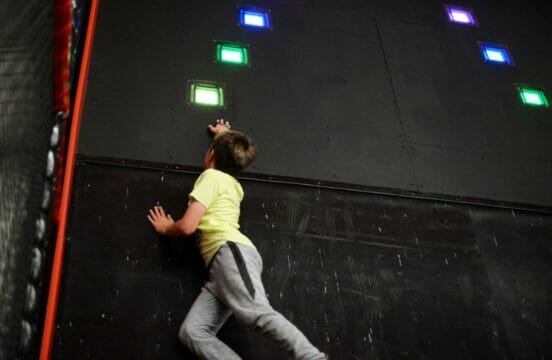 Child running up Beat The Wall at TAG X